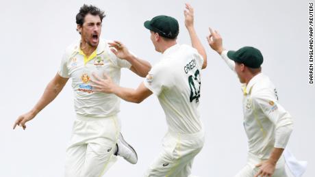 Starc celebrates with teammates after getting the wicket of Burns.