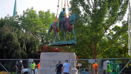 A statue of Confederate general Robert E Lee is lifted off its pedestal in Market Street Park in Charlottesville, Virginia, on July 10, 2021. 