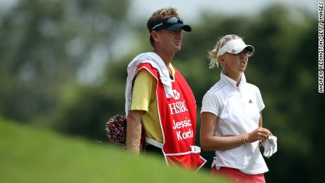 Jessica stands with her younger brother and father Petr on the 18th hole in the third round of the HSBC Women's Champions on February 26, 2011.