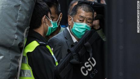 Media tycoon Jimmy Lai is escorted into a Hong Kong Correctional Services van outside the Court of Final Appeal in Hong Kong on February 1, 2021.