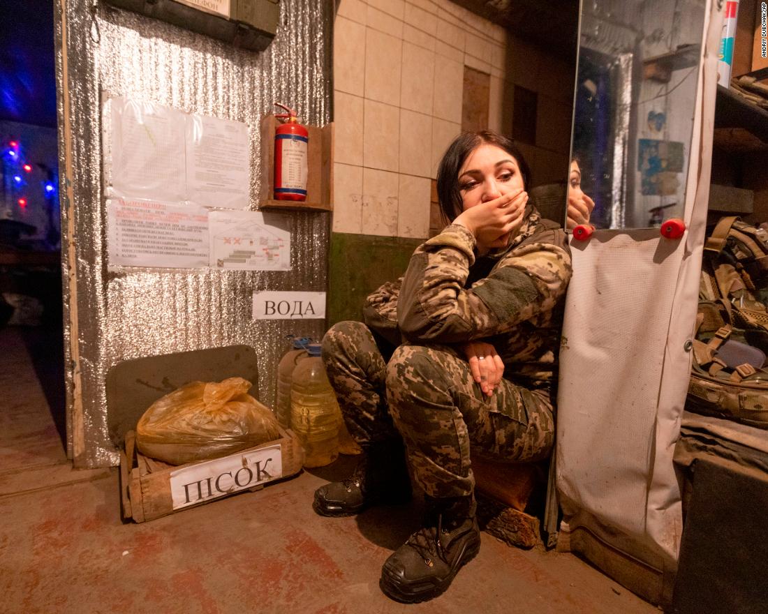 A Ukrainian soldier rests near a fighting position on the line of separation from pro-Russian rebels near Katerinivka, Ukraine, on December 7.