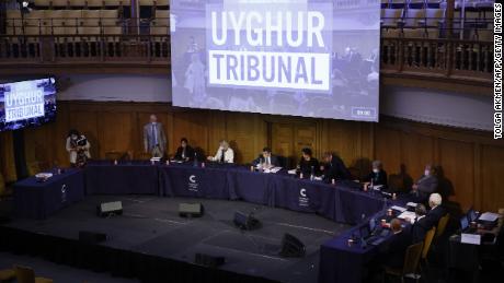 Panel members take their seats for the first day of hearing at the Uyghur court on June 4, 2021.
