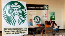 Richard Bensinger, left, who is advising unionization efforts, along with baristas Casey Moore, right, Brian Murray, second from left, and Jaz Brisack, second from right, discuss their efforts to unionize three Buffalo-area stores, inside the movements headquarters on Oct. 28, 2021 in Buffalo, N.Y. The National Labor Relations Board is scheduled to count ballots Thursday, Dec. 9, 2021, from union elections held at three separate Starbucks stores in the Buffalo area. Around 111 Starbucks workers from the three stores were eligible to vote by mail starting last month.