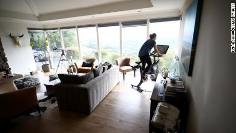 A person rides her Peloton exercise bike at her home on April 06, 2020 in San Anselmo, California.  