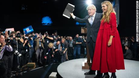 Prime Minister Boris Johnson is joined by his wife Carrie on stage after delivering his keynote speech at the Conservative Party Conference in Manchester, England, on October 6, 2021.