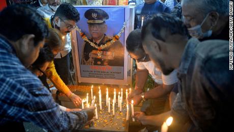 People light candles to pay their tribute to India&#39;s defense chief General Bipin Rawat, who was killed with others a day earlier in a helicopter crash, at a market area in Siliguri on December 9, 2021. (Photo by Diptendu DUTTA / AFP) (Photo by DIPTENDU DUTTA/AFP via Getty Images)