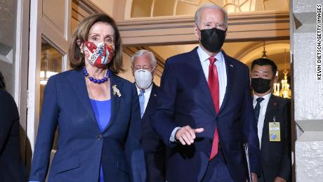 President Joe Biden walks with Pelosi as he arrives to meet with House Democrats at the Capitol in October. 