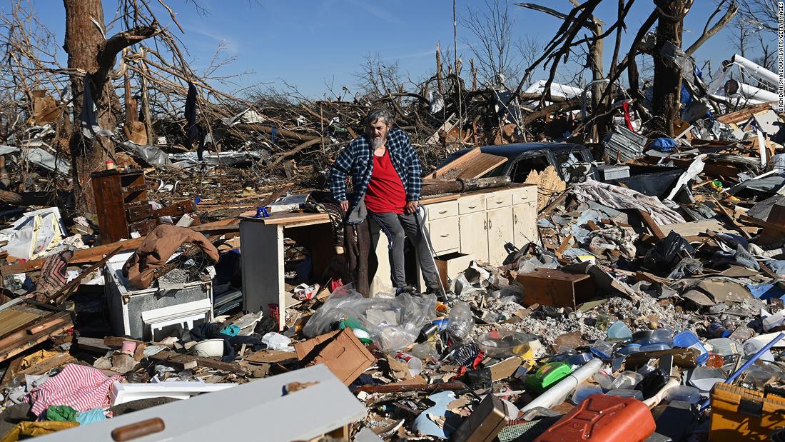 Bogdan Gaicki sits among debris on Sunday, December 12, in the Kentucky town of Mayfield after extreme weather hit the region.