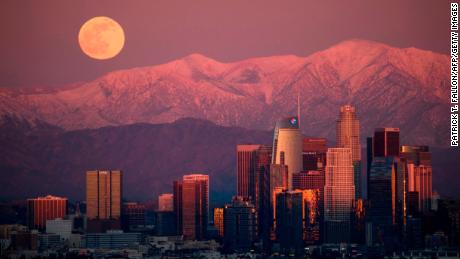 The last full moon of 2020, also known as the cold moon, rises behind the San Gabriel Mountains at sunset, as seen from the Kenneth Hahn State Recreation Area on December 29, 2020, in Los Angeles.