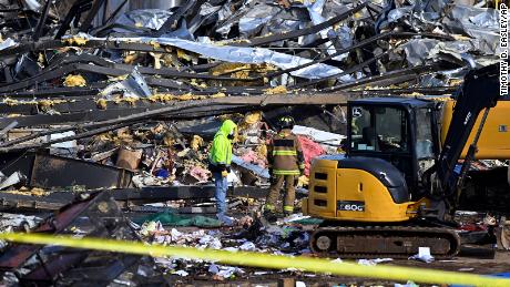 Emergency workers dig through the rubble of the Mayfield Consumer Products candle factory in Mayfield, Kentucky, on Saturday.
