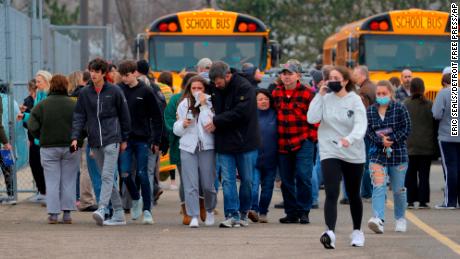 Parents retrieve their kids after the shooting at Oxford High School in Michigan on November 30. 