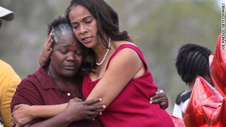 A school board member hugs a school bus driver as they return to Marjory Stoneman Douglas High School. It was the first time teachers and staff were allowed back at the school since the mass shooting in February 2018. 
