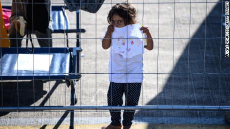 A young evacuee from Afghanistan holds up a drawing at the US military base in Ramstein, Germany, on October 9, 2021.