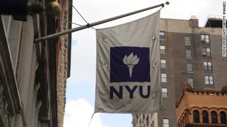 NEW YORK, NEW YORK - AUGUST 25: A New York University (NYU) flag flies outside a Covid-19 test tent outside of the NYU business school on August 25, 2020 in New York City. All students arriving back to the campus are required to get tested for the virus upon arrival and must be tested again seven to 10 days later. Classes are set to begin on September 2. (Photo by Spencer Platt/Getty Images)