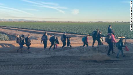 Migrants who have just crossed the border, walk into Yuma.