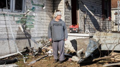 Melissa Lamb stands in front of her detroyed home in Dawson Springs.