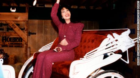 Singer Selena Quintanilla-Pérez, known as Selena, rides in a carriage during a performance at the Houston Livestock Show &amp; Rodeo at the Houston Astrodome, February 26, 1995. 