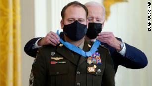 President Joe Biden presents the Medal of Honor to Army Master Sgt. Earl Plumlee for his actions in Afghanistan on Aug. 28, 2013, during an event in the East Room of the White House, Thursday, Dec. 16, 2021, in Washington. (AP Photo/Evan Vucci)