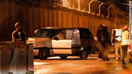 Israeli security forces inspect a car that came under gunfire near a settlement in the  West Bank on December 16, 2021.