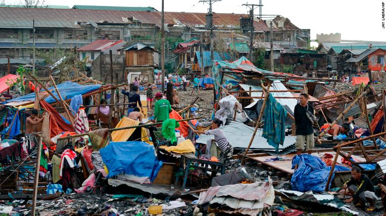 Residents salvage what's left of their damaged homes following Typhoon Rai in Cebu, central Philippines on December 17, 2021.