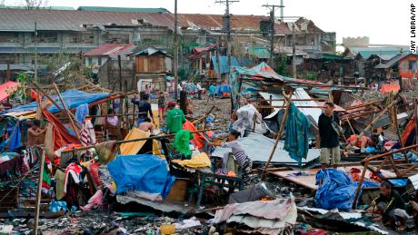 Residents salvage what&#39;s left of the their damaged homes caused by Typhoon Rai in Cebu city on Friday, December 17, 2021. 