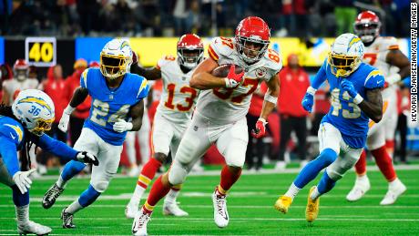 Kelce carries the ball for the touchdown during overtime against the Chargers.