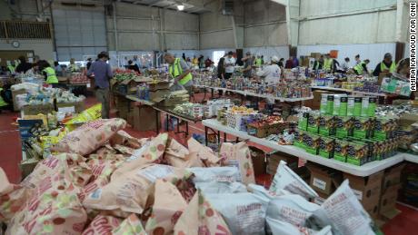 Food, clothing and other supplies are arranged at a supply center in Mayfield on 15 December.