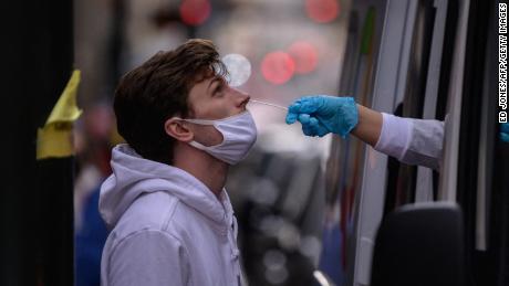 A man receives a nasal swab during a test for Covid-19 at a street-side testing booth in New York on December 17, 2021.