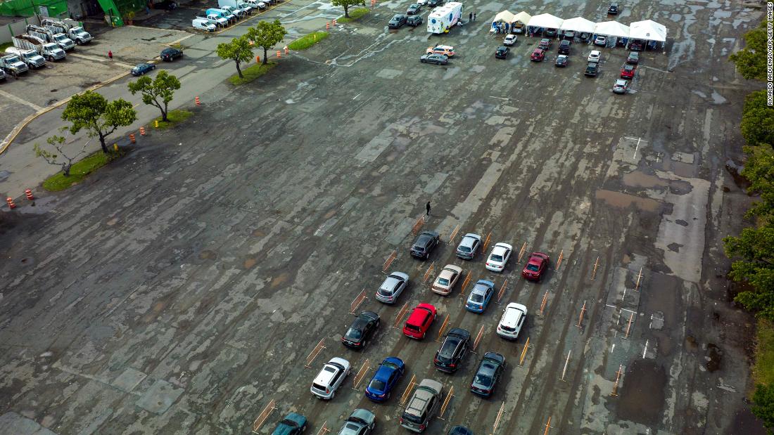 Drivers wait in line to be tested for Covid-19 at the Hiram Bithorn Stadium parking lot in San Juan, Puerto Rico, December 18.