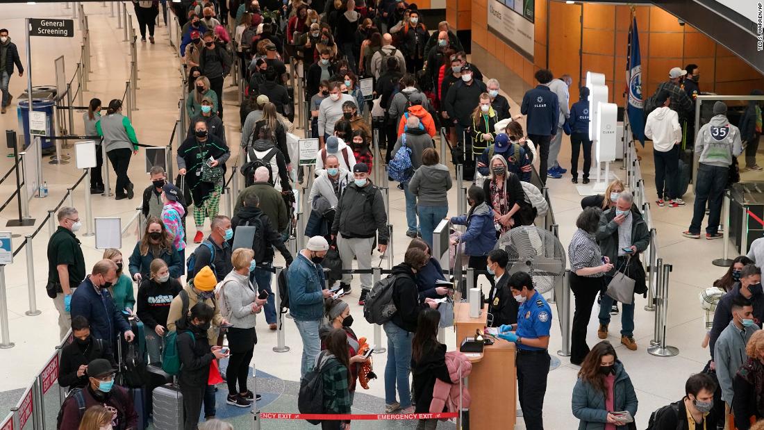 Travelers wait in a line for a security check December 10, at Seattle-Tacoma International Airport.