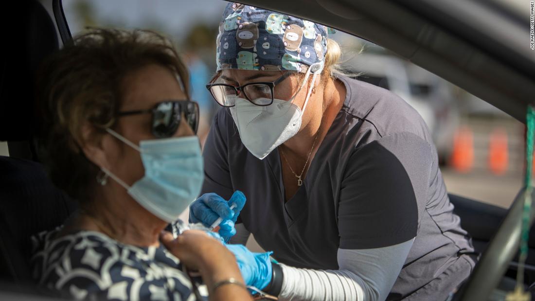 A healthcare worker administers a Pfizer-BioNTech Covid-19 vaccine to a person at Tropical Park in Miami December 16.