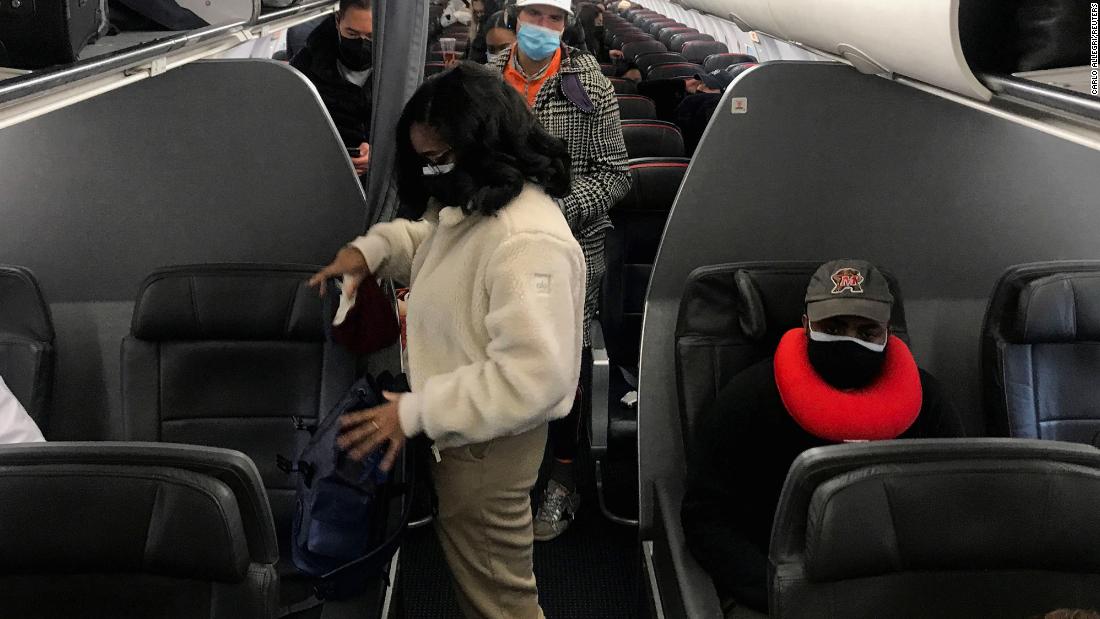 Travelers prepare to get off an American Airlines flight at Ronald Reagan Washington National Airport in Washington, DC, December 18. 