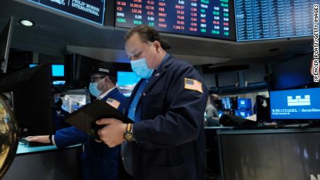 A trader works on the floor of the New York Stock Exchange (NYSE) at the start of trading on Monday following Friday&#39;s steep decline in global stocks over fears of the new omicron Covid variant on December 20, 2021 in New York City. Stocks fell sharply in morning trading with the Dow falling over 500 points. 