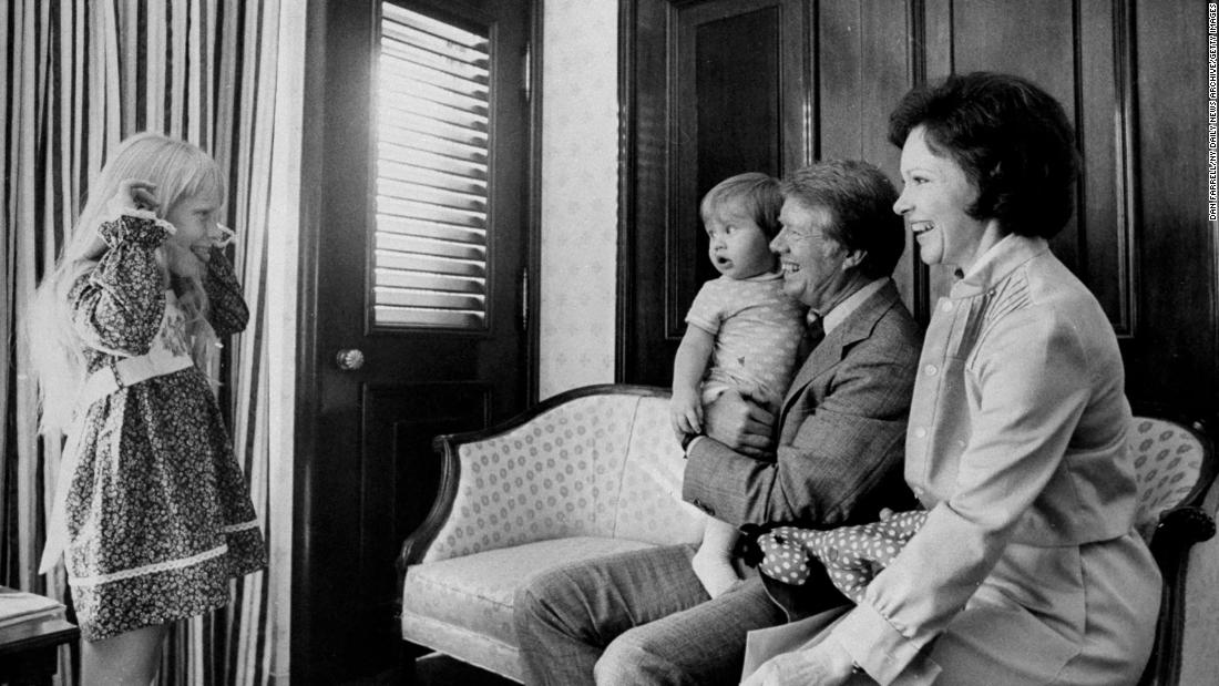 The president holds his grandson Jason as he and Rosalynn watch their daughter, Amy, in July 1976. The Carters also have three sons: Jeff, Chip and Jack. Jason is Jack&#39;s son.