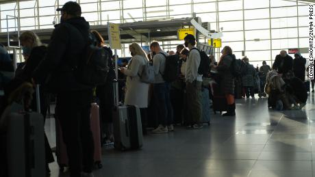Travelers wait on line December 13 to check in at John F. Kennedy International Airport.