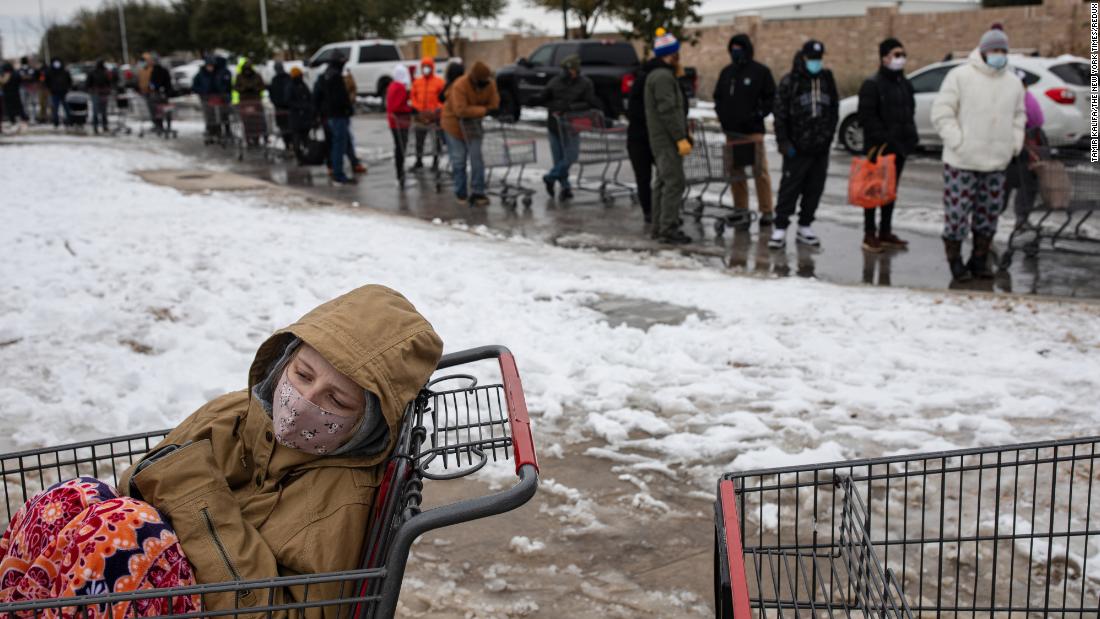 Camilla Swindle, 19, sits in a shopping cart as she and her boyfriend wait in a long line to stock up at a grocery store in Austin, Texas, on February 16, 2021. 