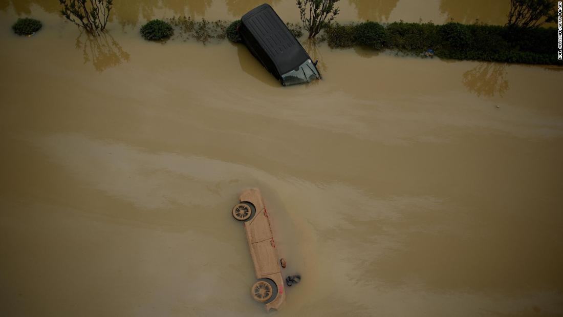 Cars sit in floodwaters following heavy rain in Zhengzhou in China&#39;s central Henan province on July 22, 2021.