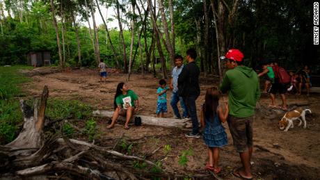 Alessandra Korap, a female leader and climate change activist from the Munduruku tribe, meets with members of the Sawré Muybu village before setting off on a patrol to monitor illegal Amazon mining.