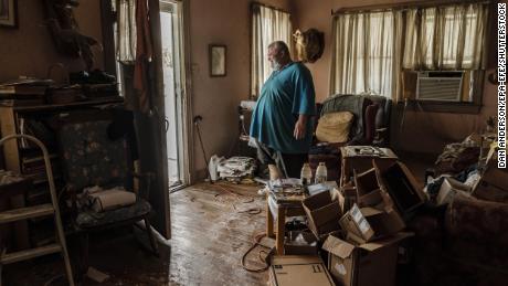 Michael Wilson stands in the doorway to his flood-damaged home after Hurricane Ida made landfall as a Category 4.