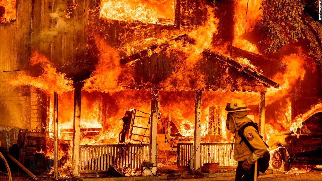 A home is engulfed in flames as the Beckwourth Complex Fire tears through Doyle, California, on July 10, 2021. 