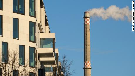 Exhaust emerges from the smokestack of a natural-gas fired power plant near a residential area in the city center on January 21, 2020 in Berlin, Germany. Germany is seeking to reduce its CO2 emissions in accordance with the Paris climate agreement.