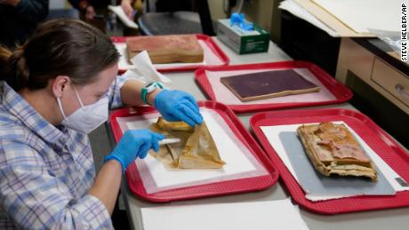 Sue Donovan, a conservator for Special Collections at the University of Virginia, works with the artifacts found in the first time capsule.