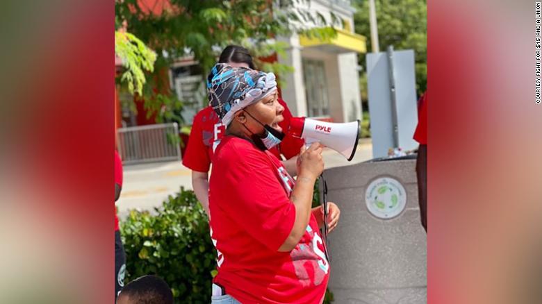 Deatric Edie, a McDonald&#39;s manager in Florida, is &quot;very concerned&quot; about the Omicron variant. She is a member of the Fight for $15 movement. She is photograpohed here rallying support for a minimum wage increase in September. 