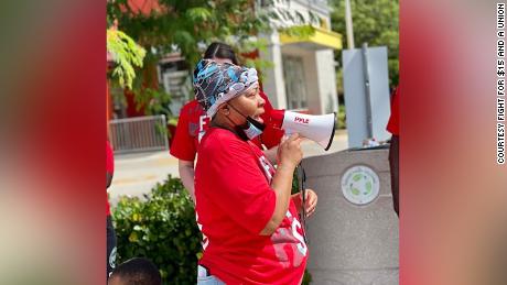 Deatric Edie, a McDonald&#39;s manager in Florida, is &quot;very concerned&quot; about the Omicron variant. She is a member of the Fight for $15 movement. She is photograpohed here rallying support for a minimum wage increase in September. 