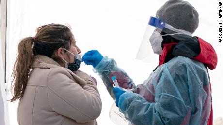 A woman is tested for COVID-19 at a walk-up testing site at Farragut Square on Thursday, Dec. 23, 2021, just blocks from the White House in Washington. (AP Photo/Jacquelyn Martin)