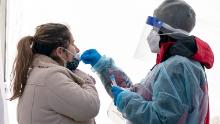 A woman is tested for COVID-19 at a walk-up testing site at Farragut Square on Thursday, Dec. 23, 2021, just blocks from the White House in Washington. (AP Photo/Jacquelyn Martin)