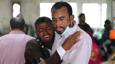 A man is consoled at a government hospital after a ferry caught fire in Khalakathi, Bangladesh on December 24.
