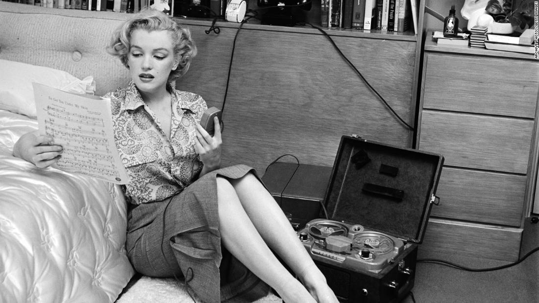 She was in several movies in 1950, including &quot;The Asphalt Jungle&quot; and &quot;All About Eve.&quot; Seen here, Monroe is reading sheet music while sitting on a bedroom floor with a tape player on her side.
