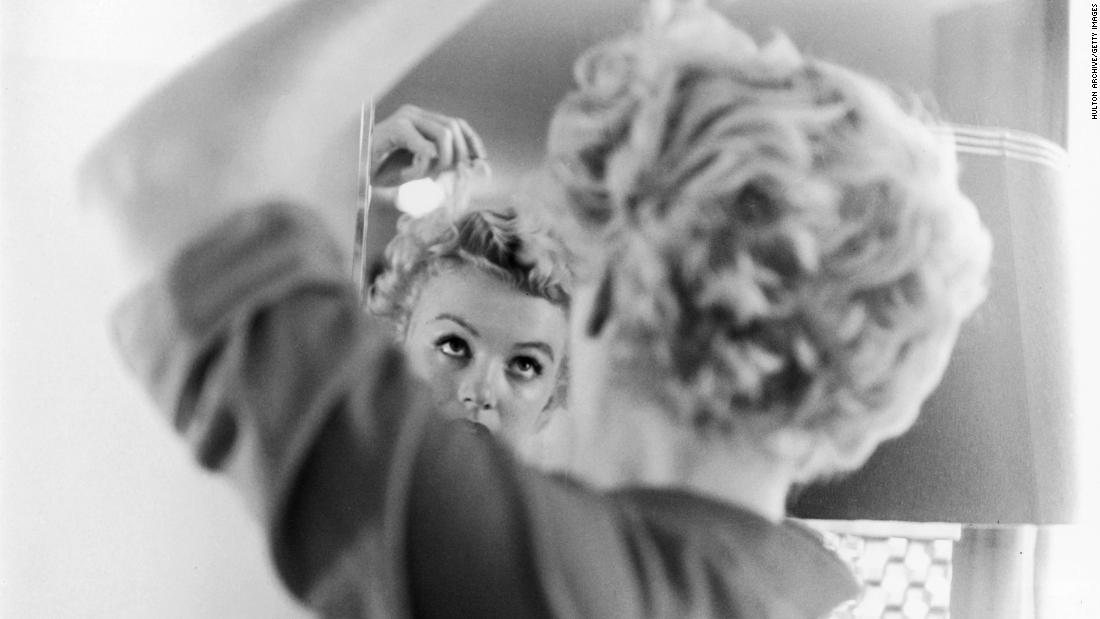 Monroe fixes her hair in front of a mirror in 1951. That year she had several supporting roles in comedies, including &quot;As Young as You Feel,&quot; &quot;Love Nest&quot; and &quot;Let&#39;s Make It Legal.&quot;&lt;br /&gt;&lt;br /&gt;&quot;If you happen to have blonde hair, you&#39;re considered dumb. I don&#39;t know why that is. It&#39;s very -- I think it&#39;s a very limited view,&quot; Monroe said at the time.