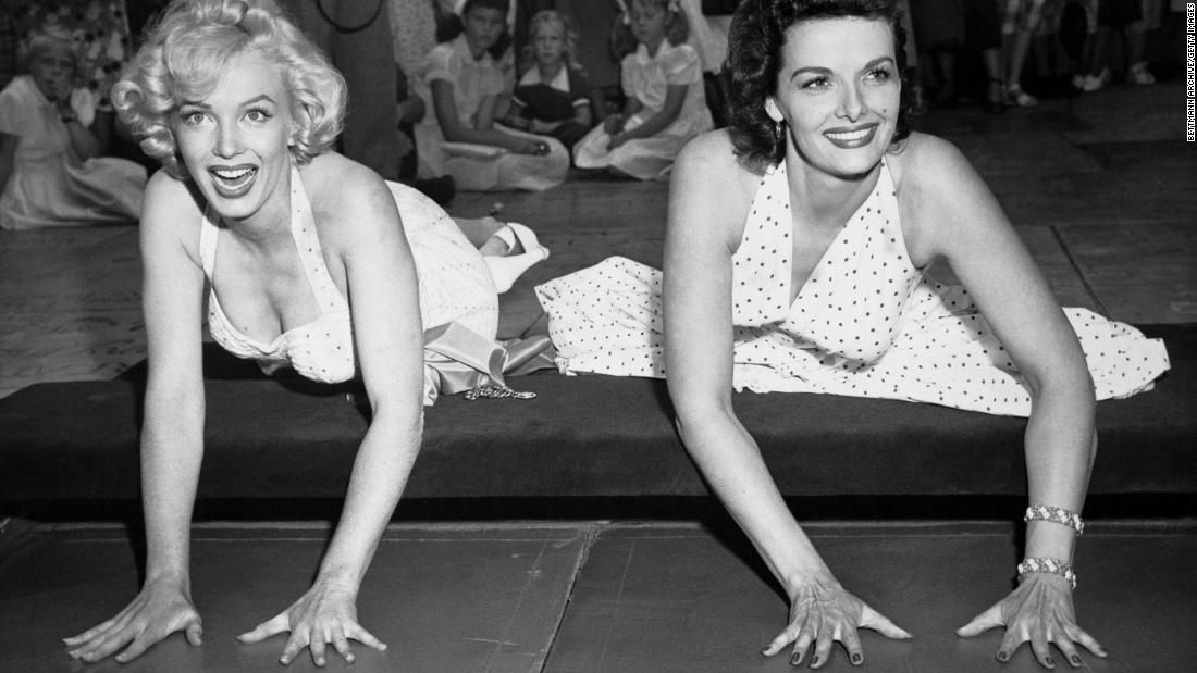 Monroe and &quot;Gentlemen Prefer Blondes&quot; co-star Jane Russell place their hands in cement at Grauman&#39;s Chinese Theatre. The musical comedy topped the box office in 1953.